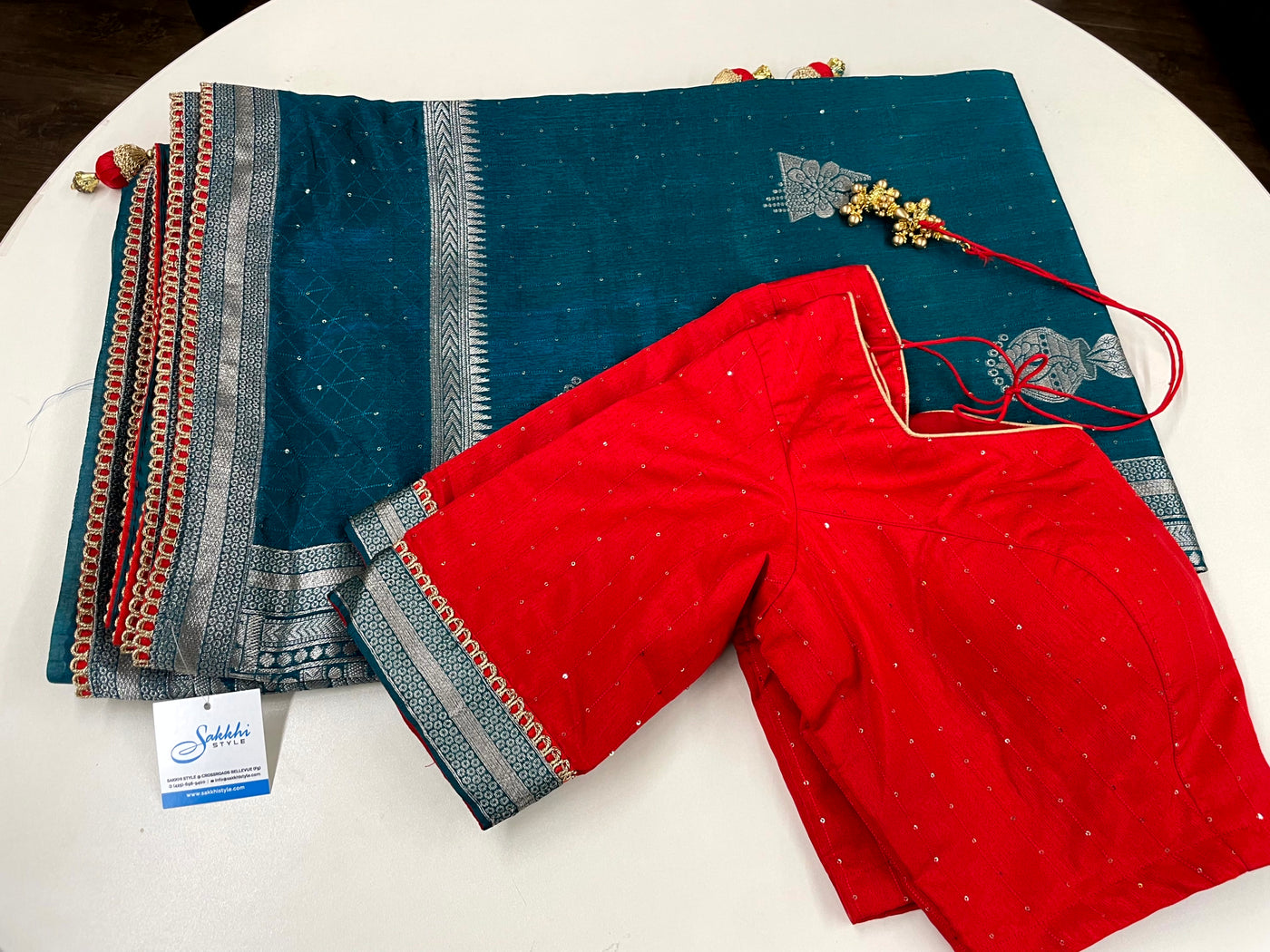 TURQUOISE COLORED TUSSAR SILK SAREE PAIRED WITH RED BLOUSE