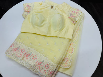 Pastel yellow embroidered Organza saree with stitched blouse