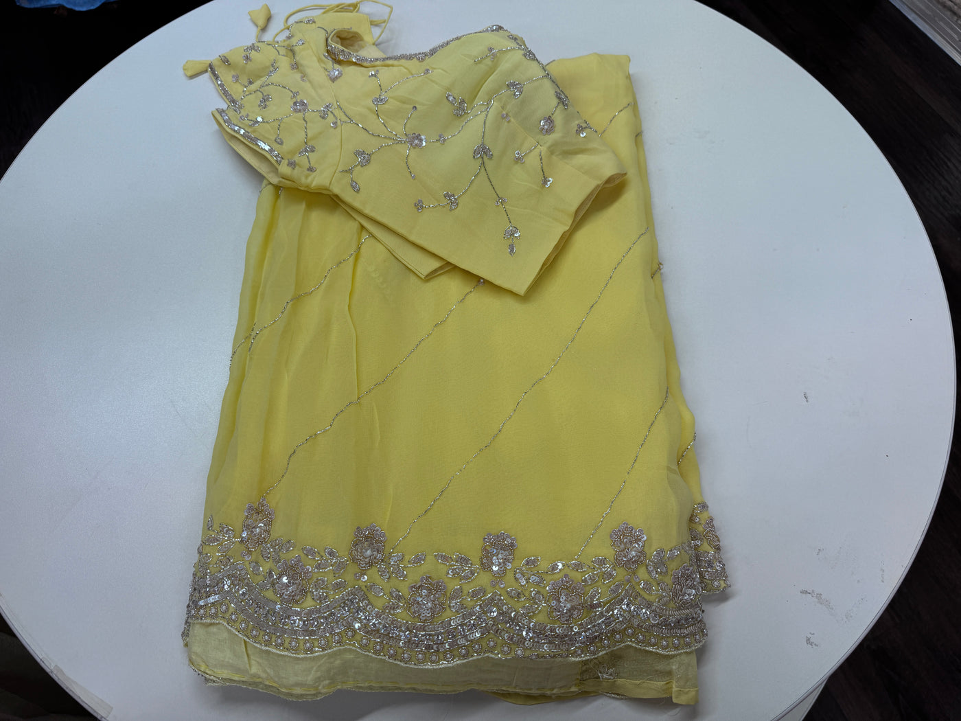 Pastel yellow embroidered georgette saree with stitched blouse