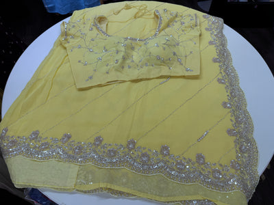 Pastel yellow embroidered georgette saree with stitched blouse