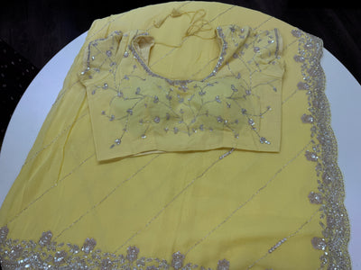 Pastel yellow embroidered georgette saree with stitched blouse