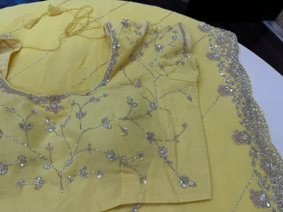 Pastel yellow embroidered georgette saree with stitched blouse