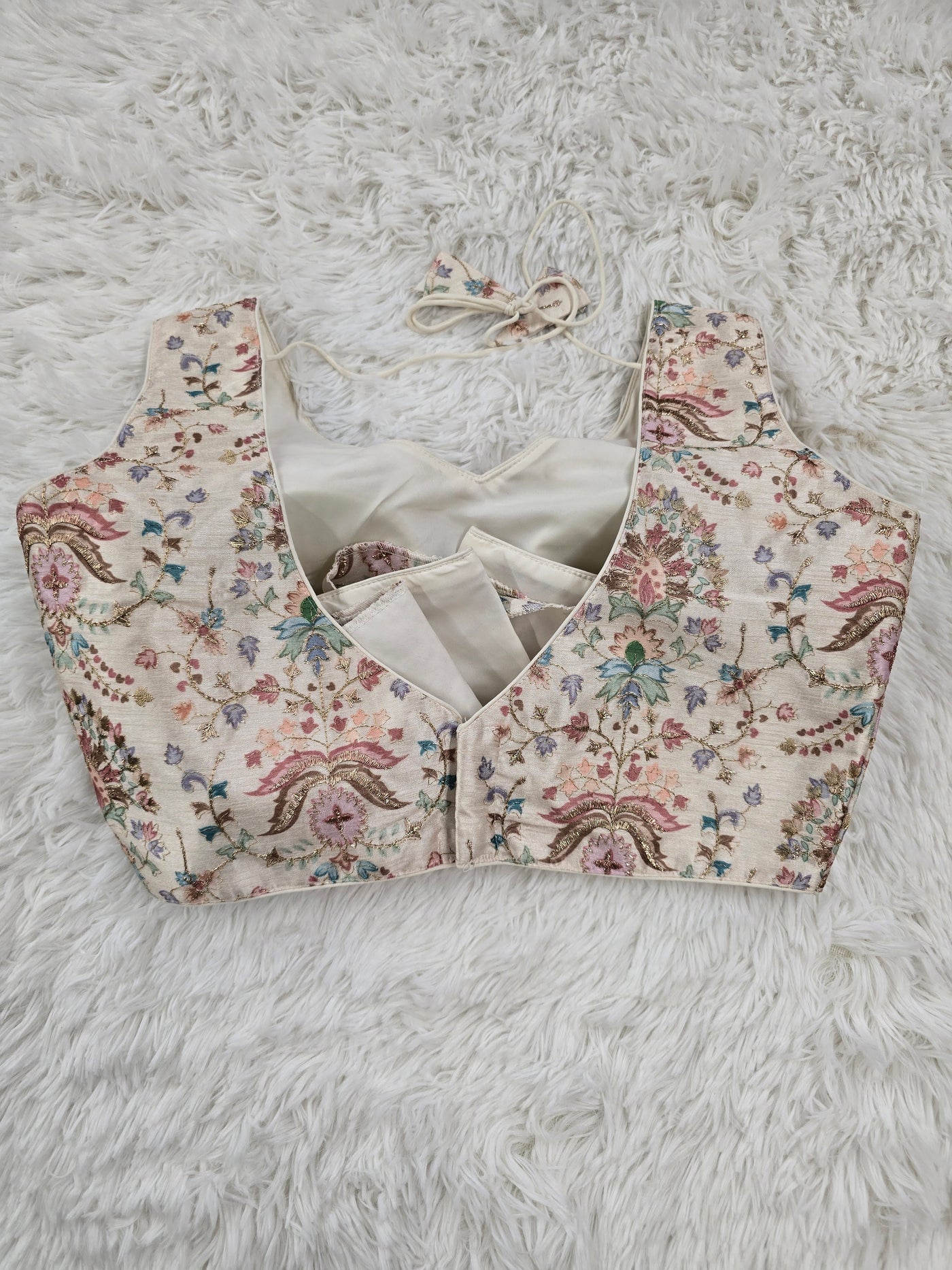 Cream Woven Silk Readymade Blouse – V-Neck Design with Pastel Floral Weaving & Tassel Tie-Back